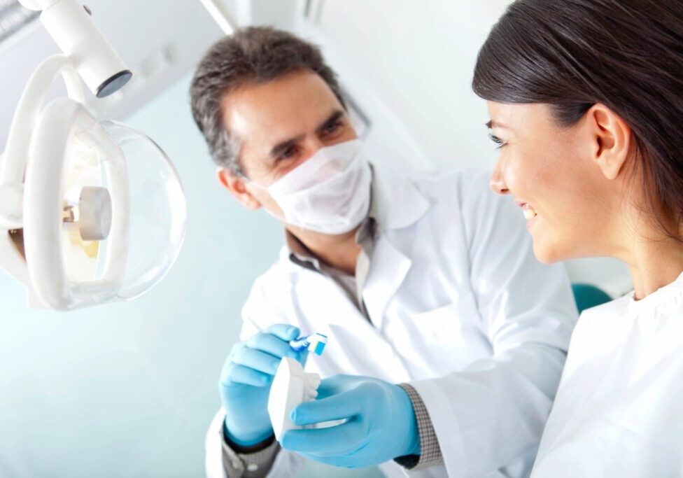a woman patient looking at a dentist